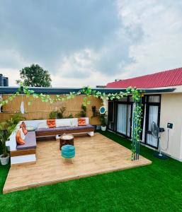 a patio with a couch and a table in a yard at Chobara707- A Royal Rooftop Escape in the Tricity in Mohali