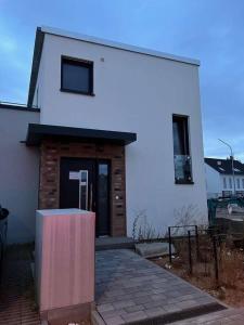 a white building with a large door at Spacious & Cozy Home with garden near Frankfurt in Hanau am Main