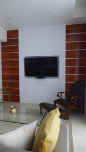 a living room with a tv on a wall at ITowers Luxury Apartment 2 in Gaborone +9 photos