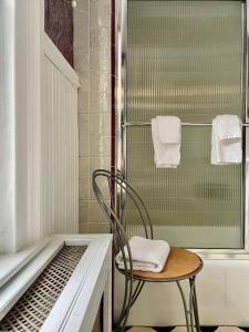 a chair in a bathroom with a shower at Twin Oaks Near Lake Wallenpaupack Historic Home in Hawley +177 photos