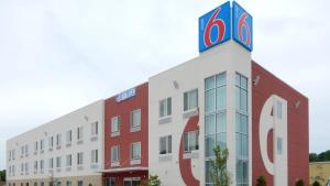 a building with a clock tower on top of it at Motel 6-Tulsa, OK in Catoosa