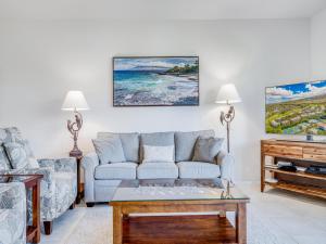 a living room with a couch and a table at Wailea Grand Champions 177 in Wailea