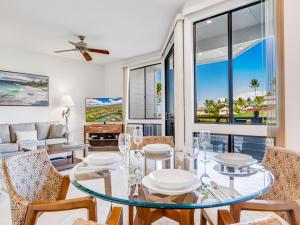 a living room with a glass table and chairs at Wailea Grand Champions 177 in Wailea