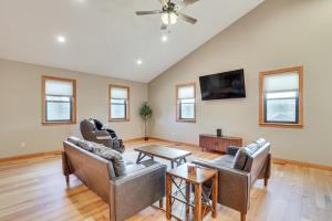 a living room with leather furniture and a flat screen tv at 6 Mi to Main St Home with Private Patio in Sturgis in Crook City