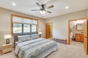 a bedroom with a bed and a ceiling fan at 6 Mi to Main St Home with Private Patio in Sturgis in Crook City