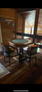 a table and two chairs in a room with a table at Rancho São Jorge in Macaé
