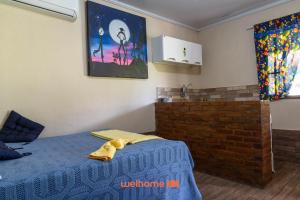 a bedroom with a bed and a brick wall at Suite em Macae com mini fazendinha e piscina in Sana