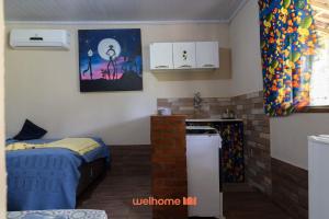 a small room with a bed and a kitchen at Suite em Macae com mini fazendinha e piscina in Sana +34 photos