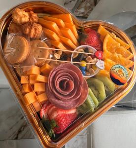 a heart shaped container filled with fruit and vegetables at Campo Adentro Cabin 2 Private Jacuzzi in Aguada