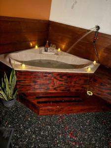 a bath tub in a room with candles in it at Campo Adentro Cabin 2 Private Jacuzzi in Aguada