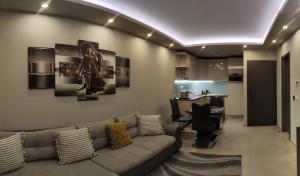 a living room with a couch and a table at Oasis Residence in Hajdúszoboszló