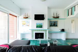a living room with a couch and a fireplace at VILLA LILLA Beachfront - Sea View with Parking and Private Garden in Anzio