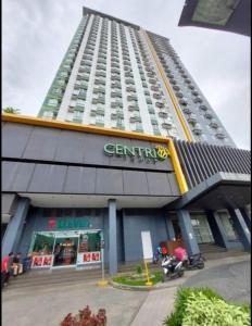 a tall building with a store in front of it at New Centrio Tower Lovely Studio adj Ayala CDO in Cagayan de Oro