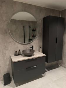 a bathroom with a sink and a mirror at The apartment in the middle of Lofoten in Vestvågøya