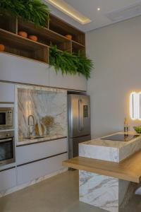 a kitchen with a counter top and a refrigerator at Loft do Edu in Ortigueira