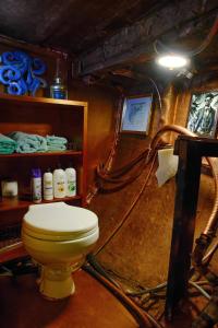 a bathroom with a yellow toilet in a room at The Victorian Voyager in Kemah