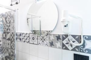 a bathroom with a mirror and a shower at La Casetta Verde con Vista Mare - Nel cuore del Parasio e delle Logge di Santa Chiara in Imperia +13 photos