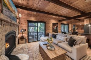 a living room with a couch and a fireplace at Songbird Cabin at Chambers by Tahoe Getaways - Pet-Friendly 2 BR with HOA Access in Homewood Seaplane Base