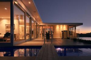 een groot huis met een zwembad ervoor bij Executive Home with Stunning Harbour views in Diamond Harbour