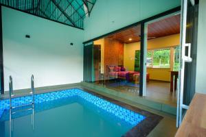 a swimming pool in the middle of a house at Private Pool Villa by Green View in Vythiri