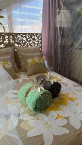 a bed with two towels and flowers on it at Chez Pilar in Avatoru
