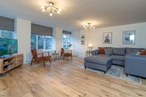 a living room with a couch and a tv at Pwerdy in Betws-y-coed