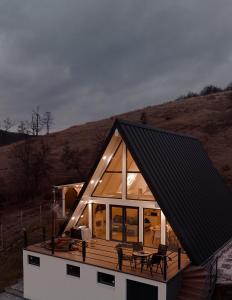 a small house with a black roof and windows at Black & White Panoramic in Rimetea