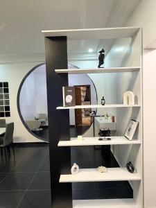 a white shelf in a room with a mirror at Haut Standing Appartement meublé Mamelles in Dakar