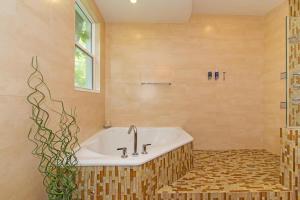 a bathroom with a bath tub and a sink at Pomegranate Cottage in West Bay +22 photos