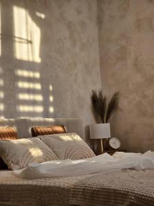 a bedroom with a bed and a lamp on a table at Apartamenty Paryskie Old Town View in Toruń