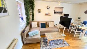 a living room with a couch and a table at Urban Oasis Stylish Boho Flat in Bristol in Bristol