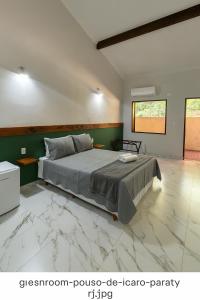 a bedroom with a large bed with marble floors at POUSADA ARUÁ PARATY - ''Novidade'' in Paraty +12 photos