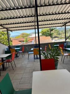 a patio with colorful chairs and tables on a roof at POUSADA ARUÁ PARATY - ''Novidade'' in Paraty