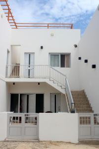 a white house with stairs and a stair case at My Boavista 2 in Sal Rei