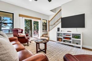 a living room with a couch and a tv at Flint Palestine Lakefront Retreat Firepit BBQ in Flint
