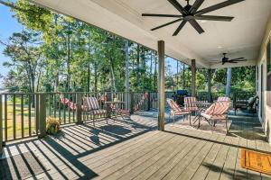 a porch with rocking chairs and a ceiling fan at Flint Palestine Lakefront Retreat Firepit BBQ in Flint