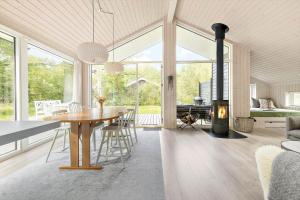 ein Esszimmer mit Tisch und Kamin in der Unterkunft 6757 Hasle - Skovtoften 16 in Hasle