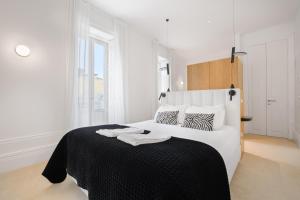 En eller flere senge i et værelse på City Retreat by Reframe stay in Porto + 50 billeder