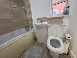 ein Badezimmer mit Toilette, Badewanne und Waschbecken in der Unterkunft Sycamore Retreat in Kettering + 36 Fotos