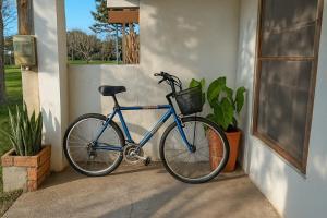 a blue bike is parked next to a building at Casa en Lago Merin Uruguay in Lago Merin