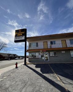 a sign in front of a building on a street at Economy Inn in Elko