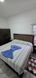 a bedroom with a bed with a blue shirt on it at Modern apartment next to the Eldorado Casino in Eldorado