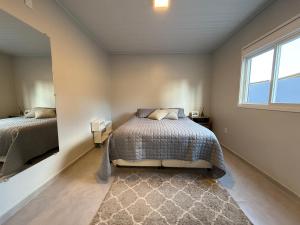 a bedroom with two beds and a window at Casa Nova com 3 quartos in São Gabriel