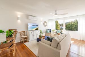 a living room with a couch and a table at Shoal Bay 83 , 83 Horace St - Air Conditioned home away from home in Shoal Bay