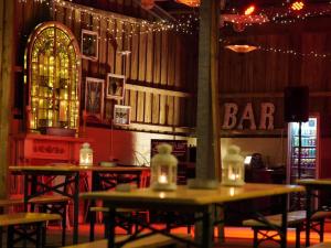 a bar with tables and chairs in a room with lights at 1 Bed in Fowey 95015 in Golant