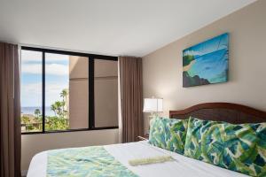 a bedroom with a bed and a large window at Kaanapali Shores 527 · KS 527 2Bedroom w Ocean Views in BeachFro in Kahana +127 photos