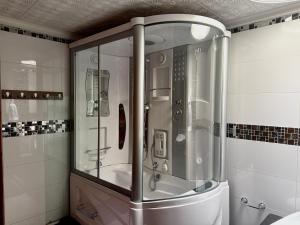 a shower with a glass door in a bathroom at Kaobba Hostal in Medellín +20 photos