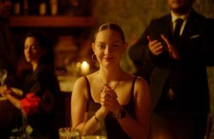 a woman sitting at a table in a bar at Ati Ambavi Botique Hotel Gudauri in Gudauri