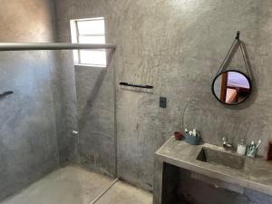 ein Badezimmer mit Waschbecken und Spiegel in der Unterkunft Estância Malucos do Vale in Delfinópolis + 39 Fotos