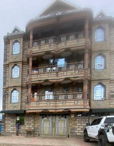 a large stone building with a balcony at Pendeza homes in Naivasha